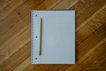 Open Notebook with Pencil