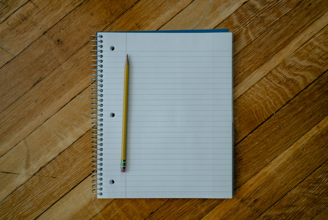 Open Notebook with Pencil