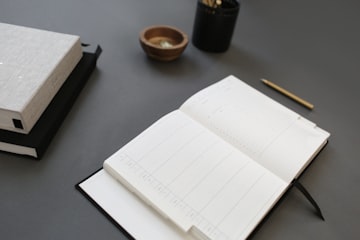Open White Notebook on Desk