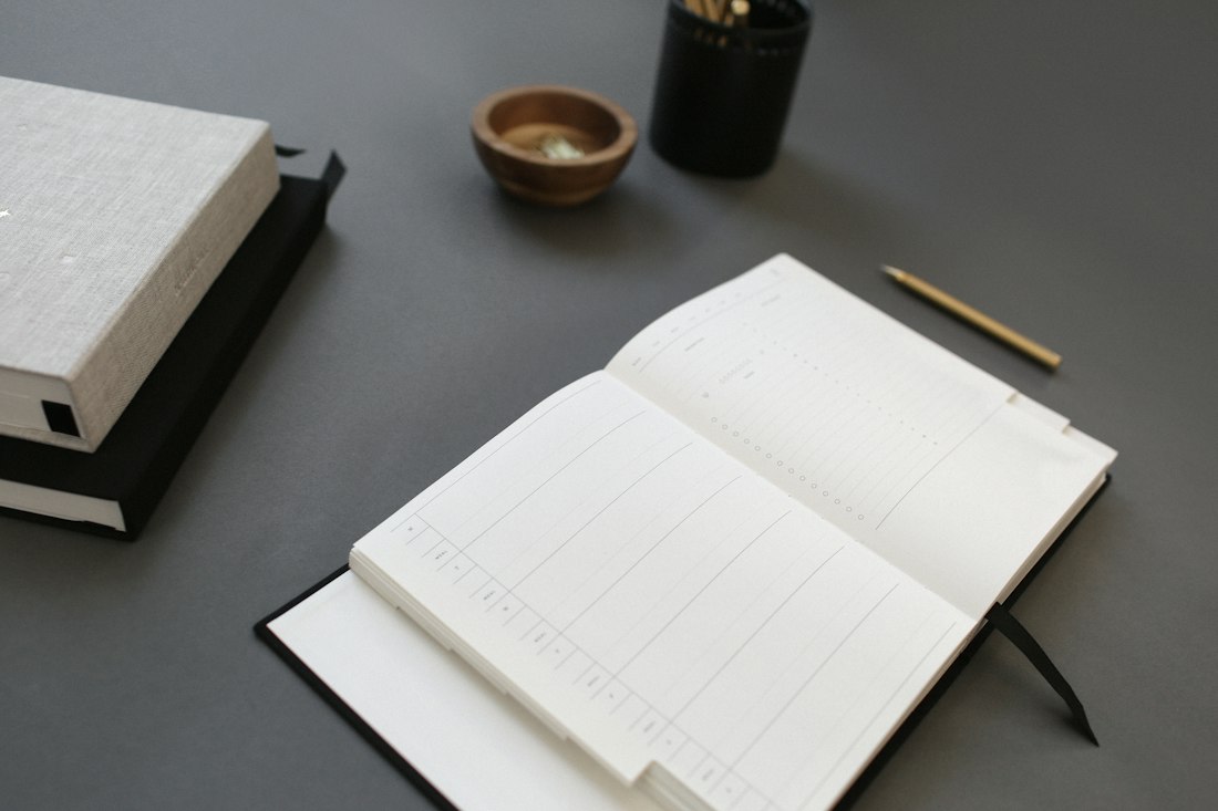 Open White Notebook on Desk