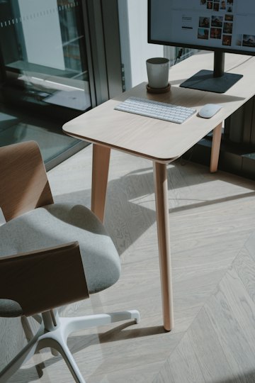 A tidy desk beside a window