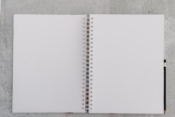 Open Spiral Notebook on Concrete
