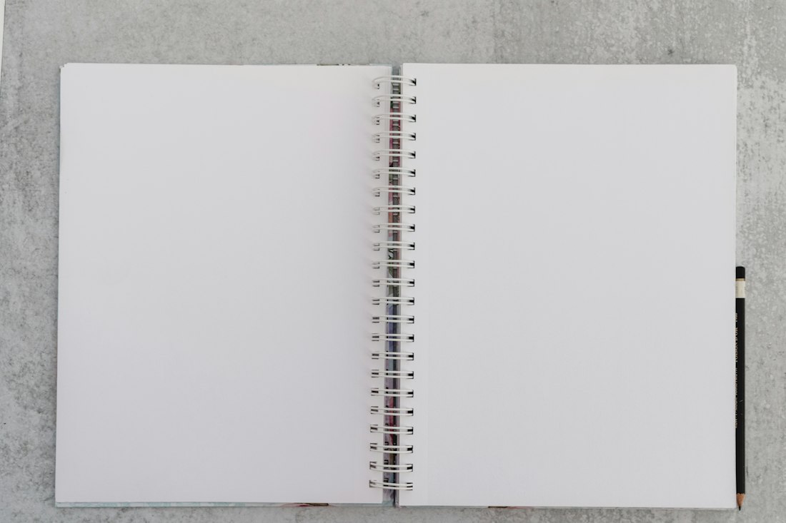 Open Spiral Notebook on Concrete